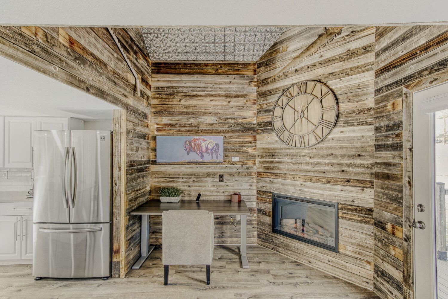 Cozy up by your rustic fireplace with reclaimed wood walls, while the modern kitchen awaits your culinary adventures.