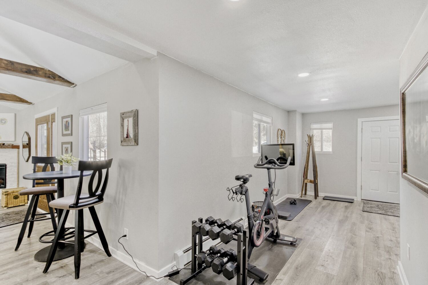Stay active in your private workout space featuring cardio equipment, weights, and a mounted TV for entertainment.