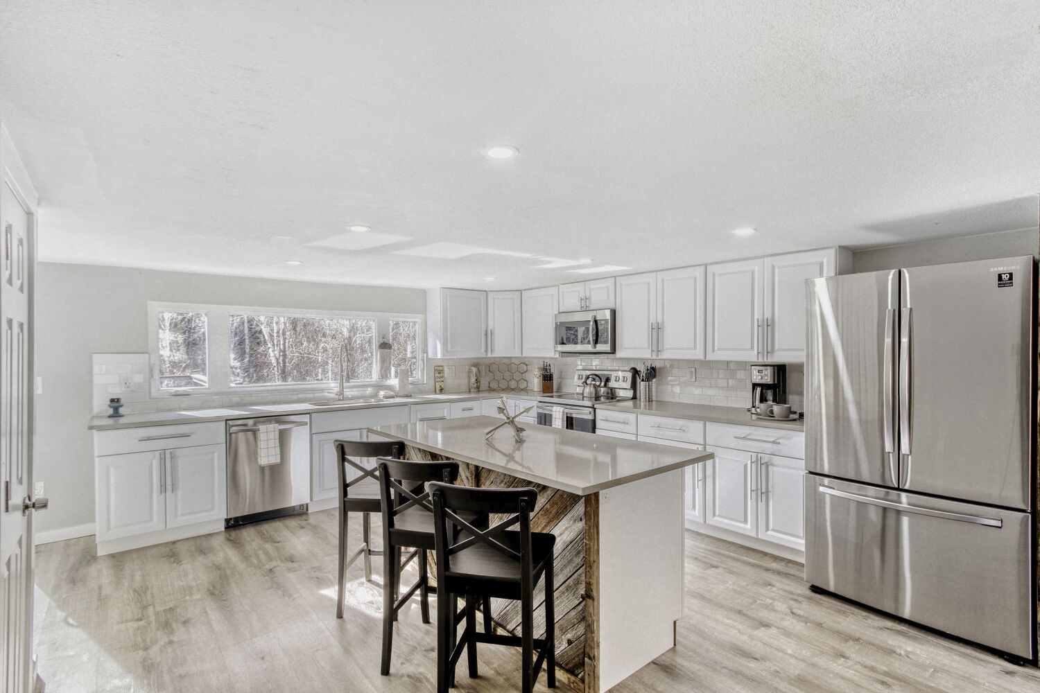 This fully equipped kitchen invites culinary adventures with gleaming granite counters, stainless appliances, and a spacious island perfect for morning coffee or evening meals.