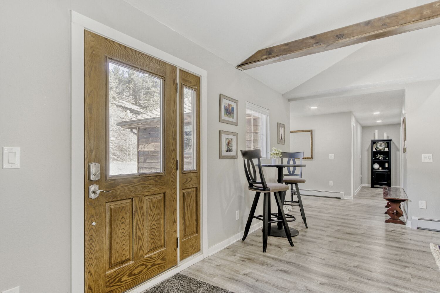Your welcoming entry opens to charming rustic-modern interiors with exposed beams, stylish dining nook, and thoughtful decor creating a cozy retreat.
