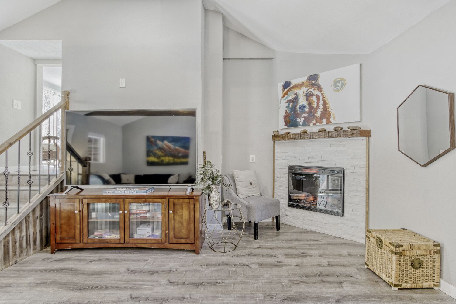 Sink into plush seating by your private fireplace in this bright, airy living space with vaulted ceilings and charming artwork.