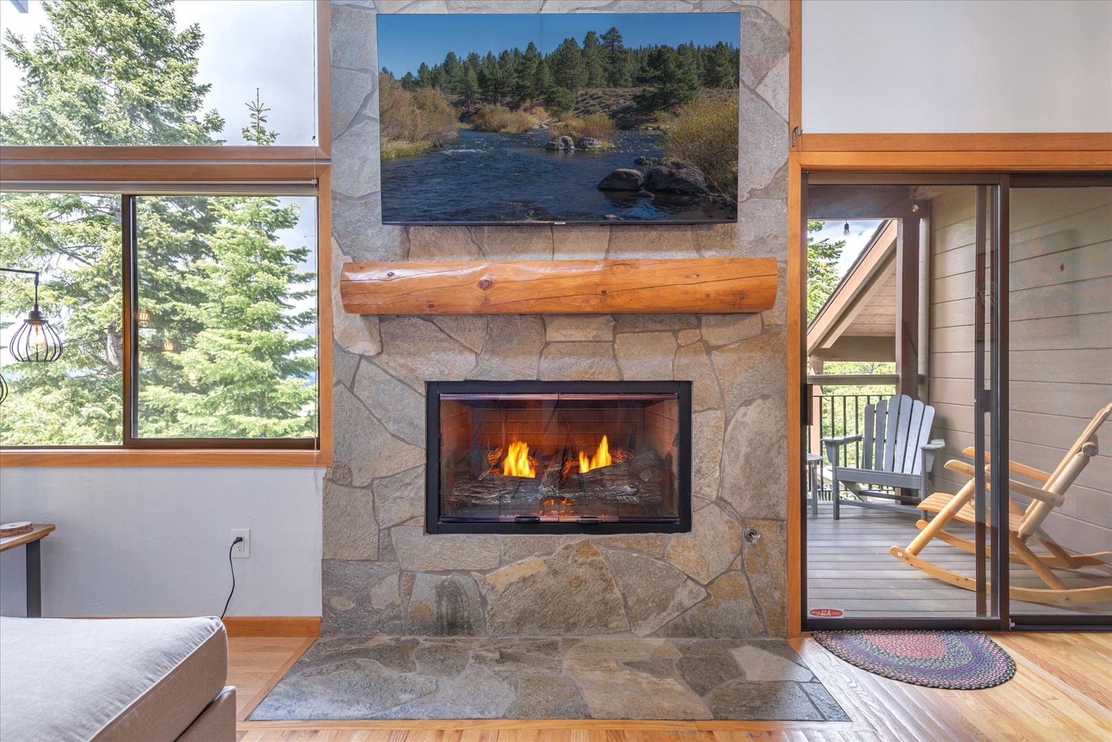 Warm up by the stone fireplace and take in forest views through floor-to-ceiling windows, or step onto the deck for fresh mountain air.
