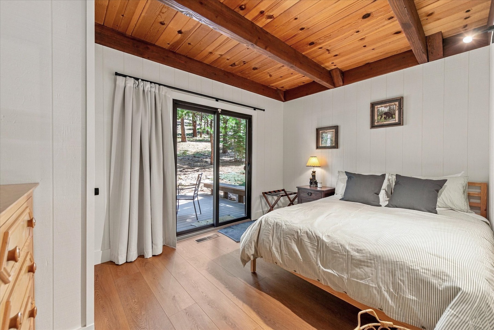 Drift off beneath striking wood-beamed ceilings, with sliding doors opening to your own private outdoor space nestled among the trees.