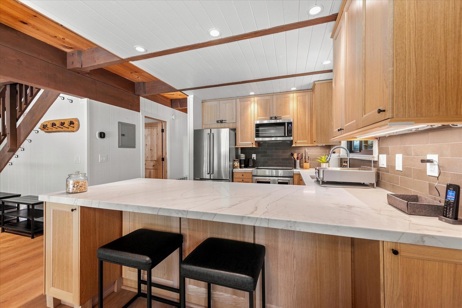 Step into your fully equipped kitchen with sleek counters, modern appliances. Perfect for cooking up a delicious meal or sharing morning coffee at the island.