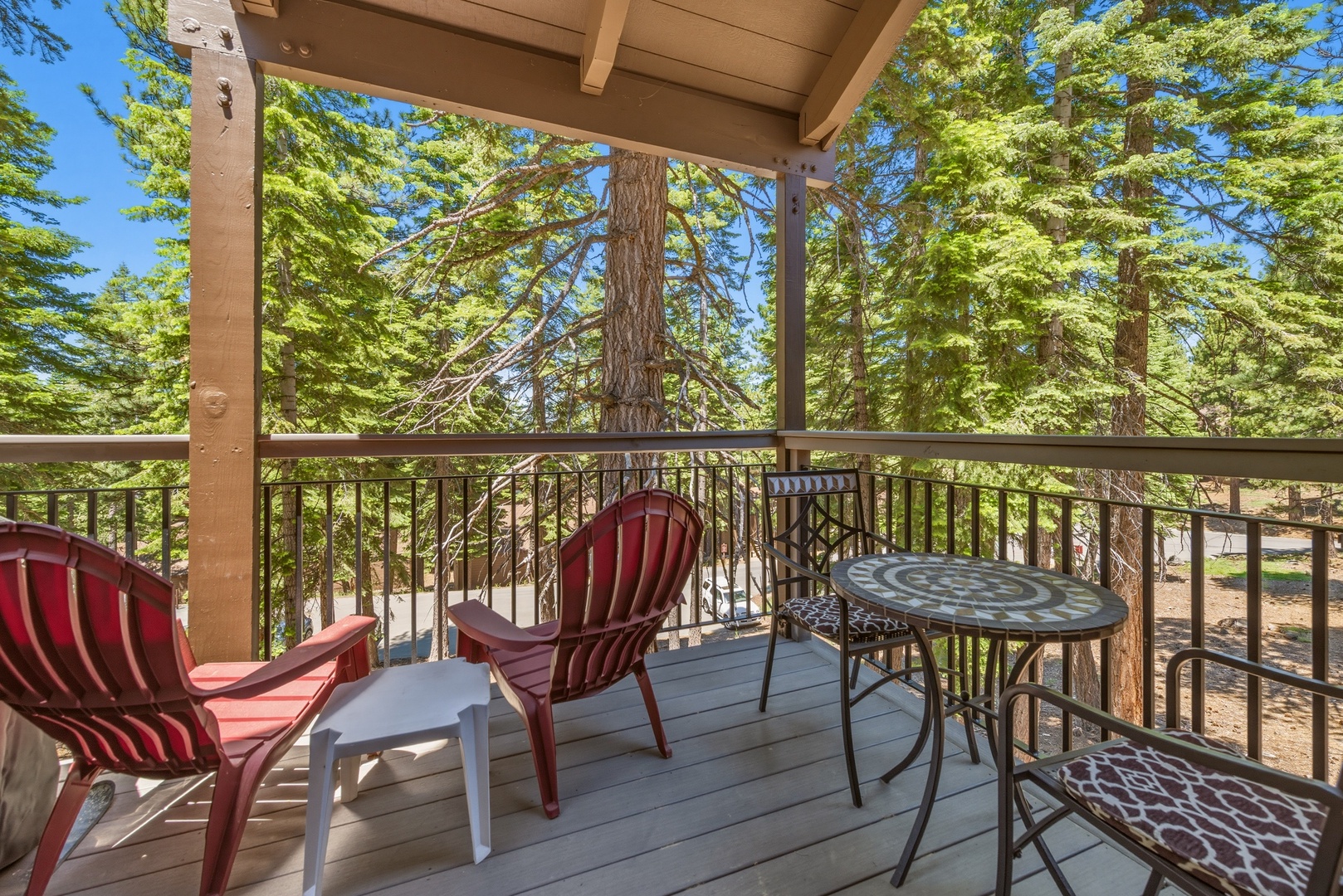Picture yourself sipping morning coffee on your private balcony, surrounded by towering pines and fresh mountain air. Comfortable seating invites you to unwind and soak in the serene forest views.