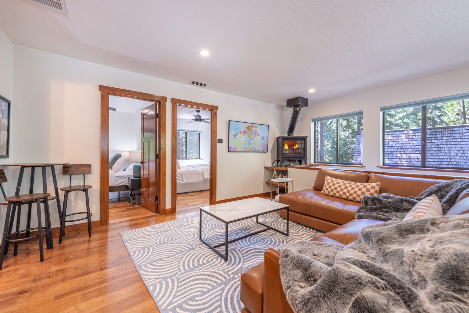 Sink into plush leather sofas and warm up by your wood-burning fireplace after exploring. This inviting upstairs living space connects you to the kitchen and two cozy bedrooms.