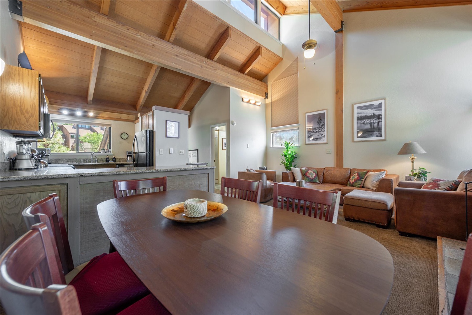 Relax in your airy, light-filled retreat with soaring vaulted ceilings and cozy leather seating. The open layout invites you to cook, dine, and unwind in style, surrounded by natural wood and soft natural light.