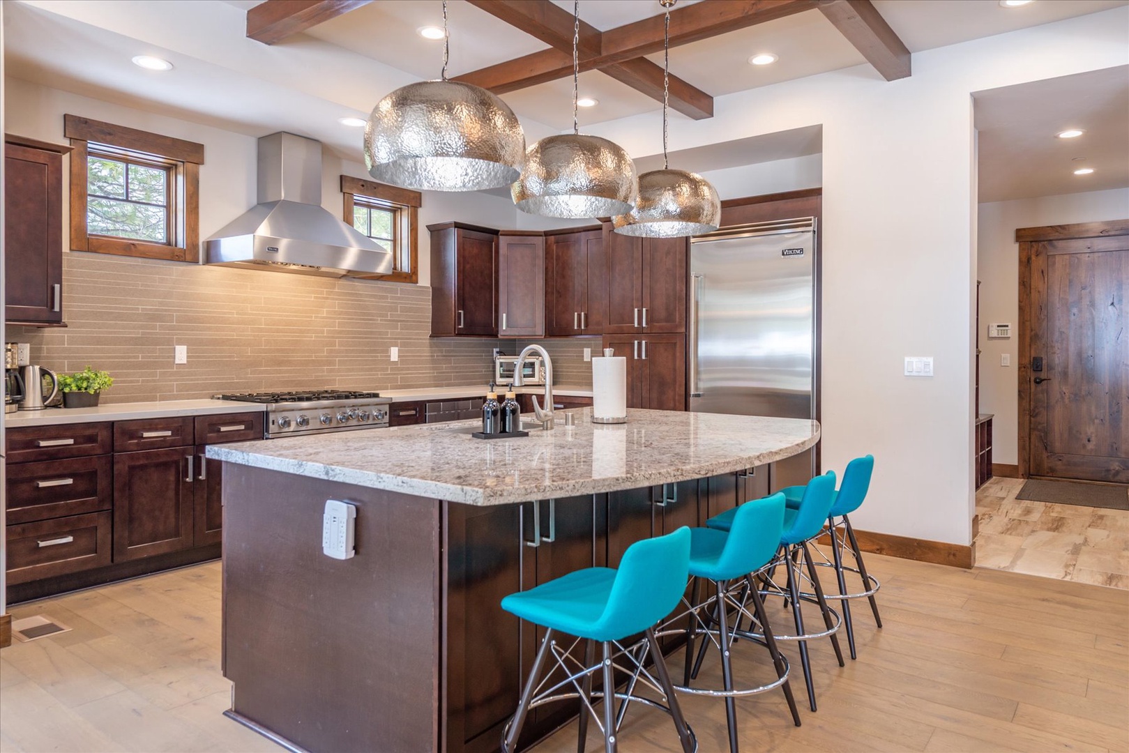 Gather around for breakfast at the kitchen island with barstool seating and stunning pendant lighting.