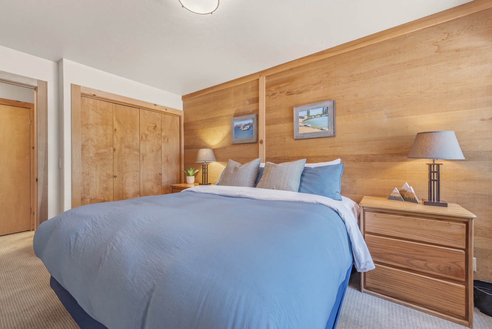 Sink into soft linens and wake up refreshed in your cozy bedroom, where warm wood accents and mountain-inspired art create a peaceful retreat for your mountain getaway.