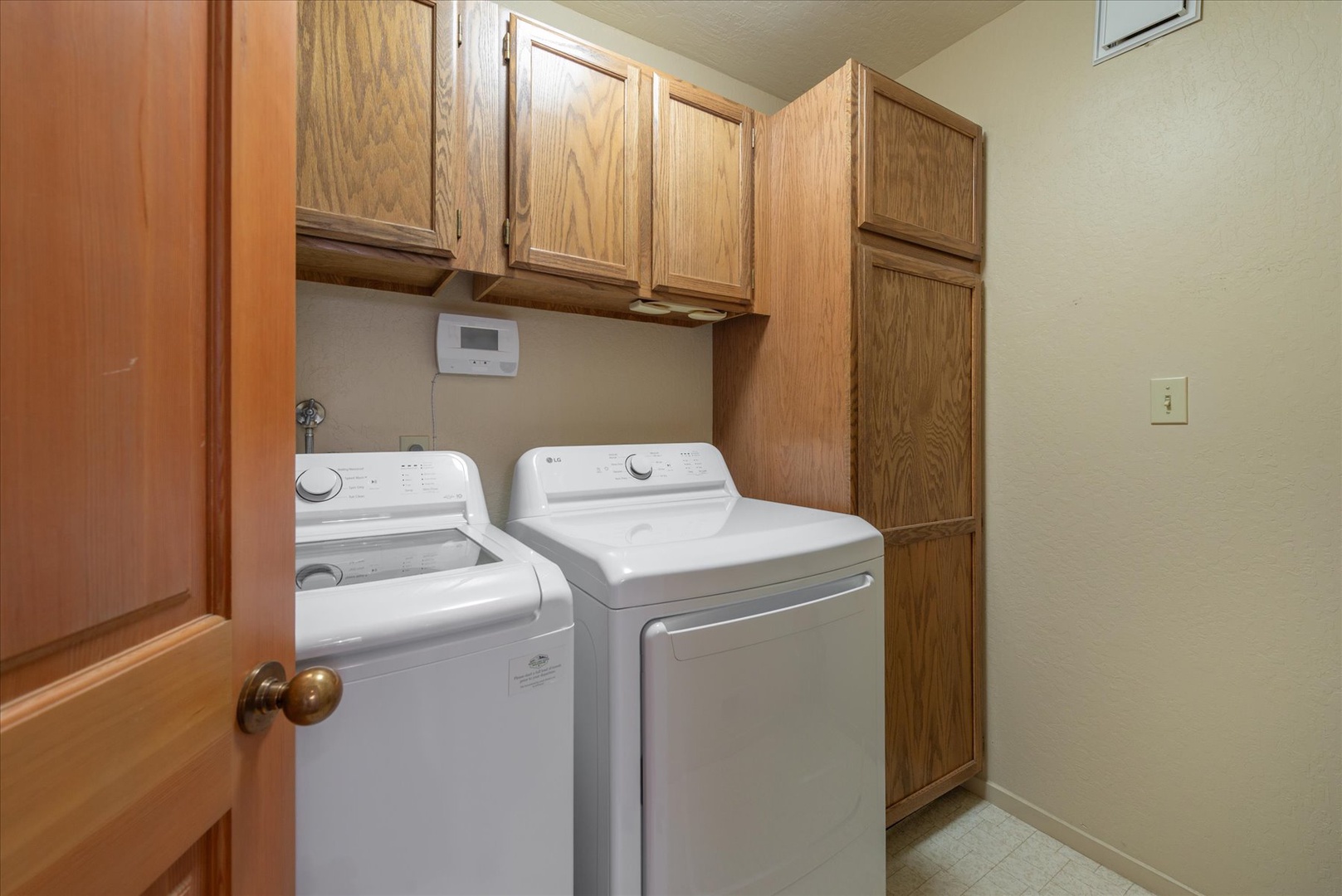 Your dedicated laundry room features a full-size washer and dryer with plenty of cabinet storage, making it easy to keep your vacation wardrobe fresh and tidy throughout your stay.