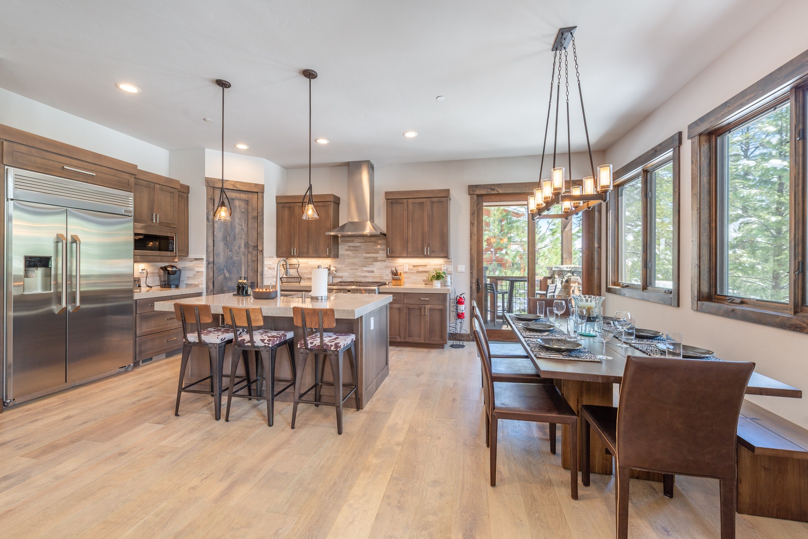 Your open-concept kitchen and dining space features warm wood finishes, stainless appliances, and a welcoming island perfect for gathering with loved ones.