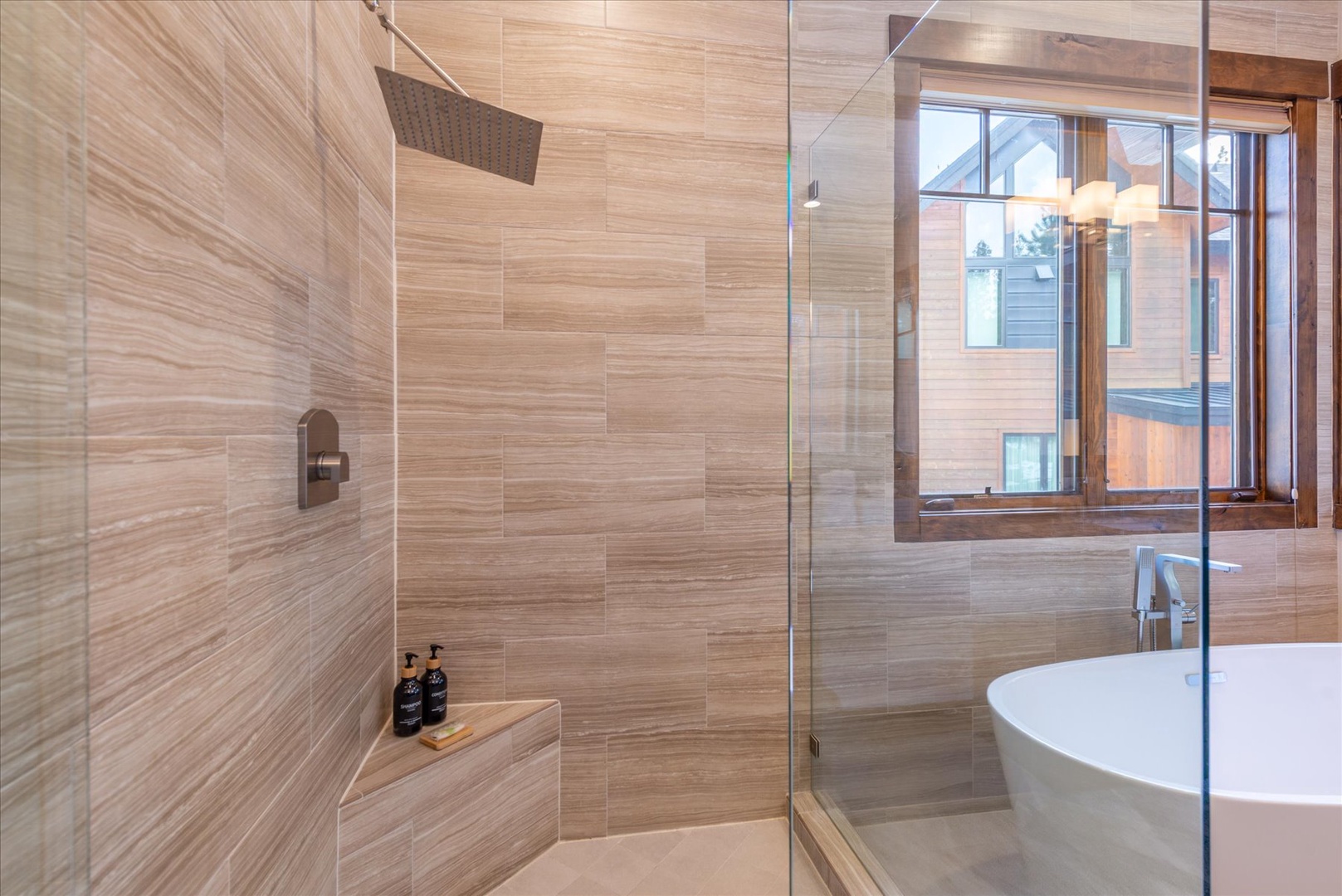 Your private spa sanctuary features a rainfall shower and elegant soaking tub, perfect for unwinding after mountain adventures.