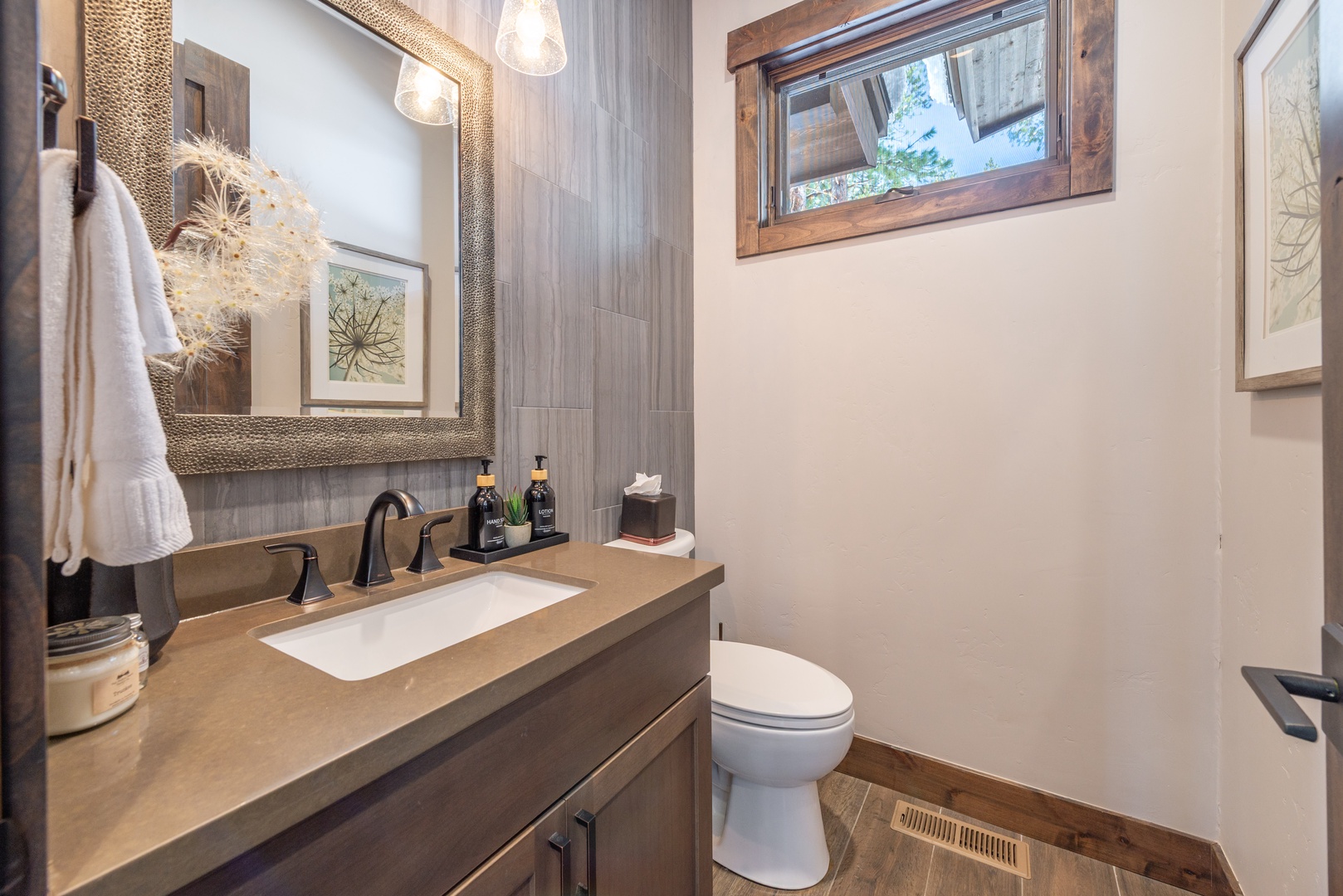 Refresh in your private powder room featuring warm wood tones, elegant fixtures, and thoughtful amenities.