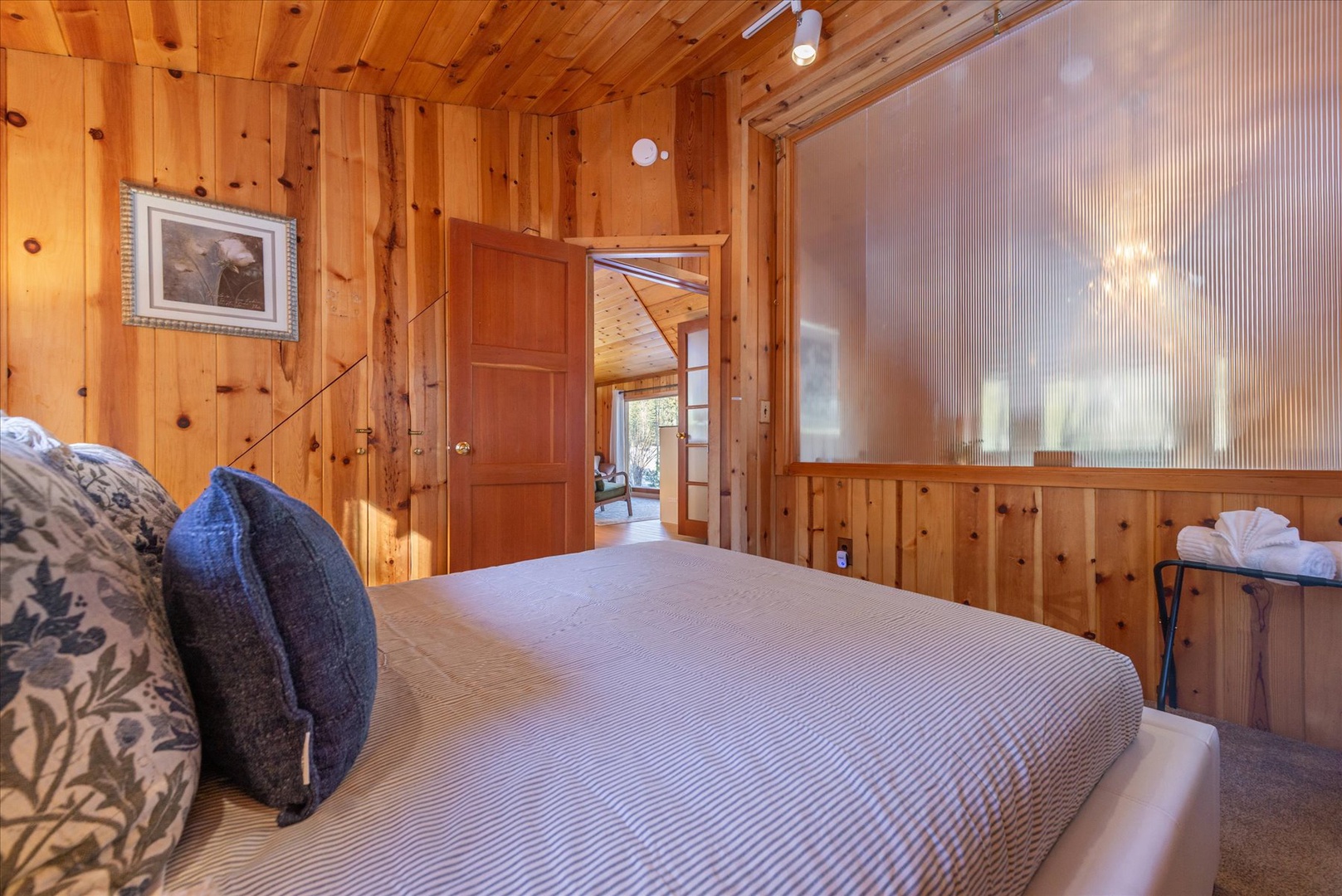 This cozy knotty pine upstairs bedroom with soft linens and rustic charm creates your perfect mountain retreat sanctuary.