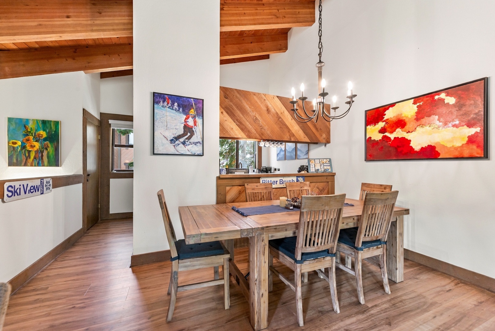Gather around the rustic wood table under soaring vaulted ceilings and warm lighting—your perfect spot for shared meals and memorable mountain evenings.