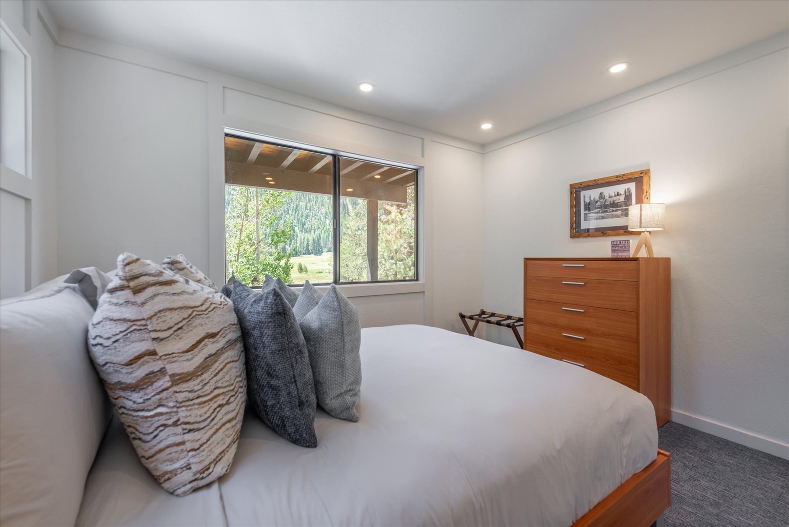 Rest easy in your serene bedroom, where crisp linens and natural light create the perfect retreat. Wake up to green views through your window, inviting peaceful mornings.