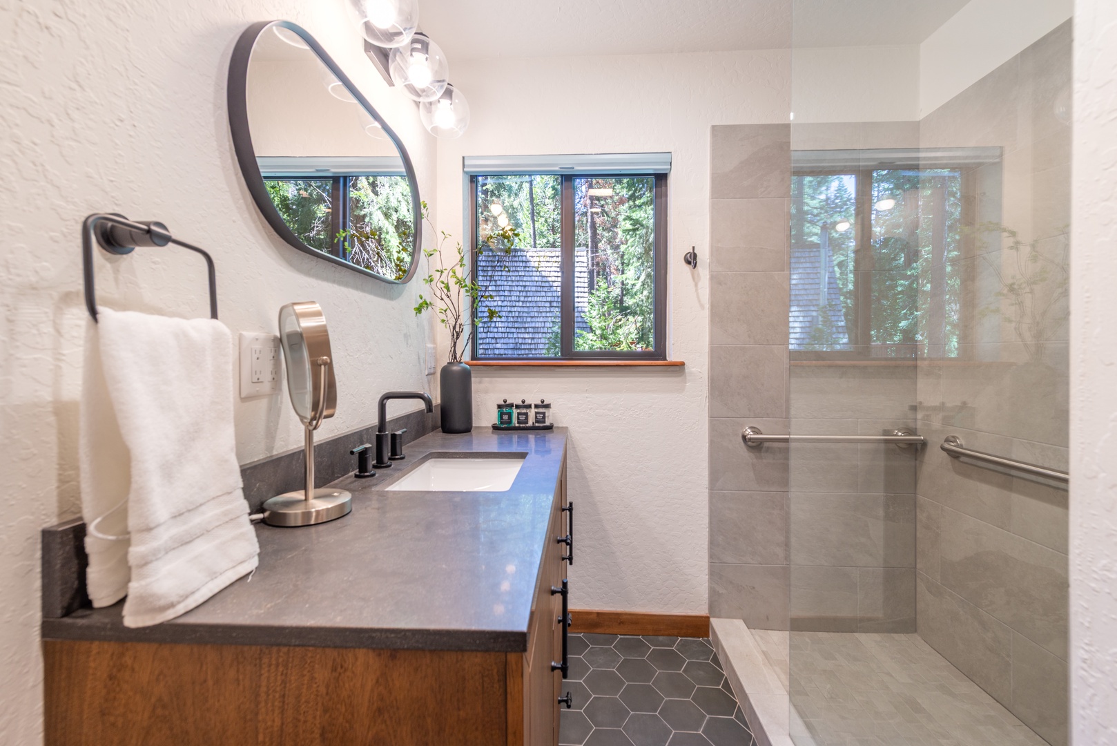 Your modern downstairs bathroom blends style and comfort, with a spacious walk-in shower and elegant vanity.