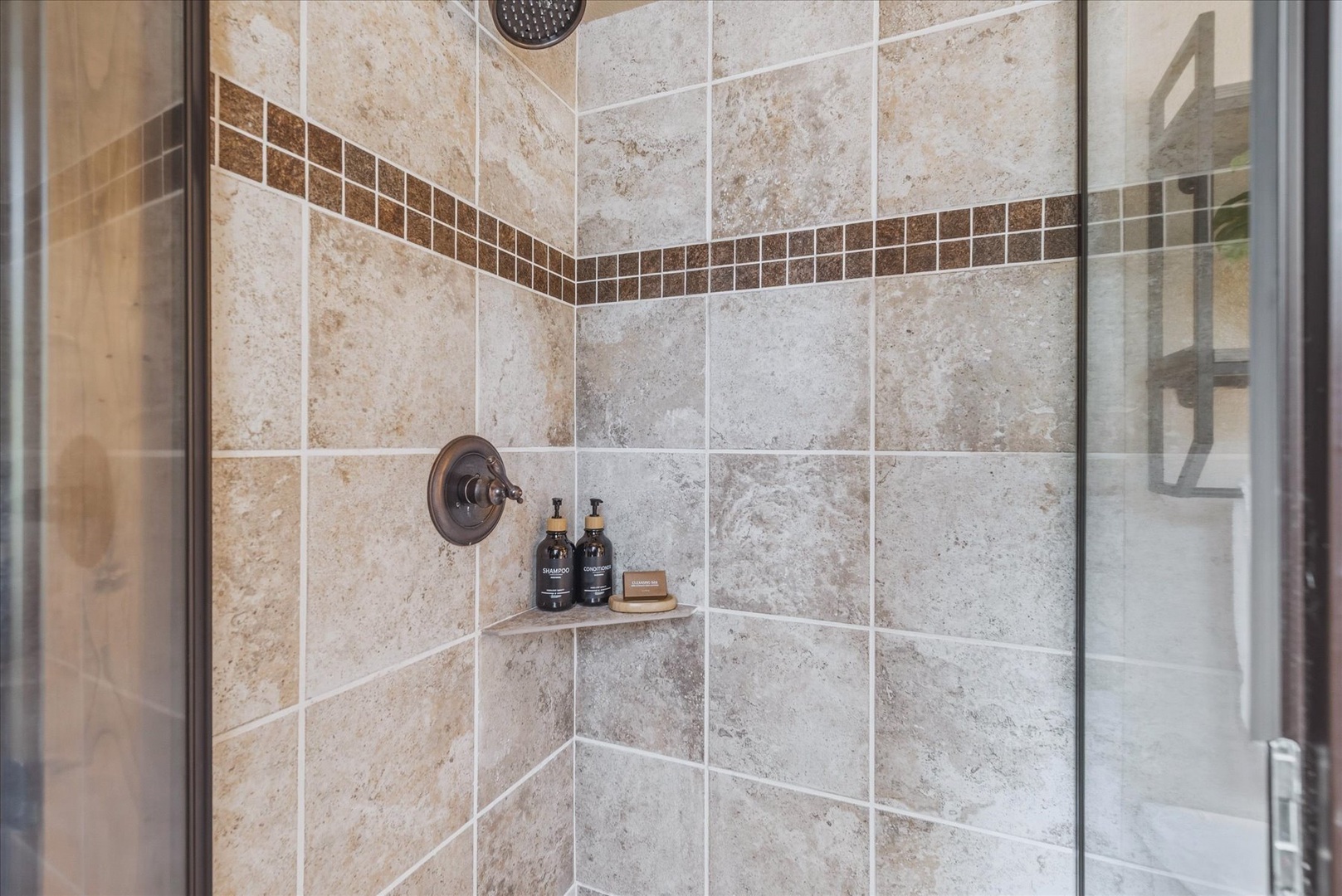 Step into your beautifully tiled walk-in shower, complete with provided bath products for your convenience.