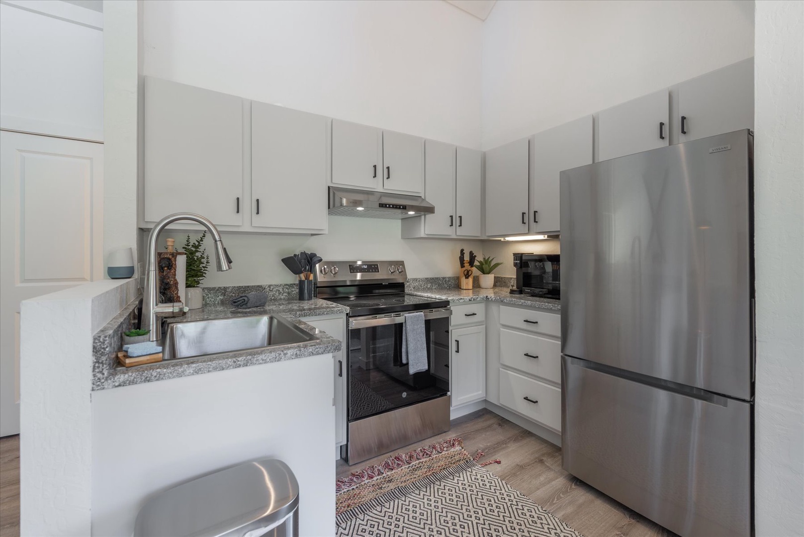 Step into your fully-equipped kitchen featuring stainless steel appliances, granite countertops, and ample storage—perfect for preparing your favorite meals during your stay.