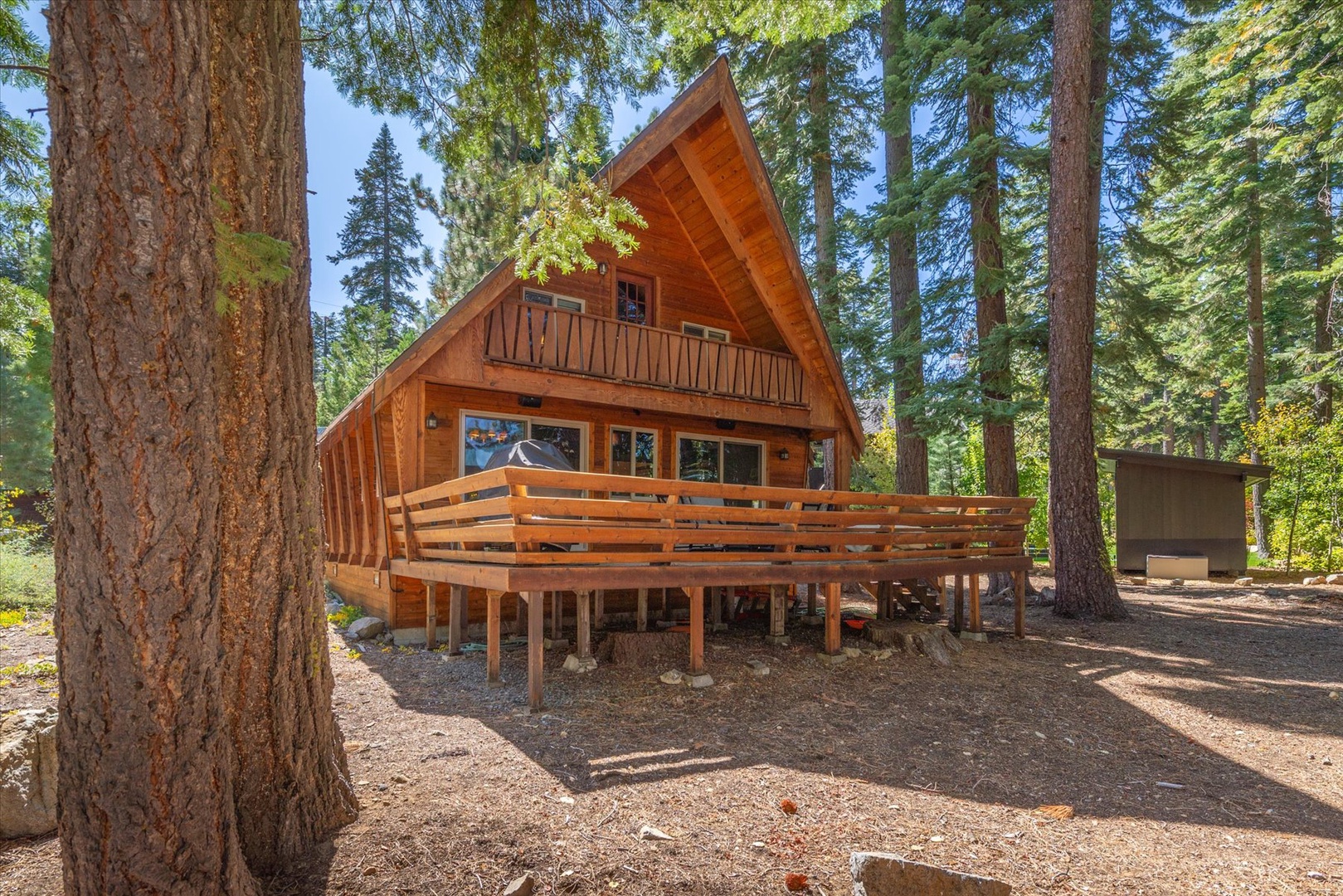 The backyard view of this Tahoe cabin, featuring a spacious deck.