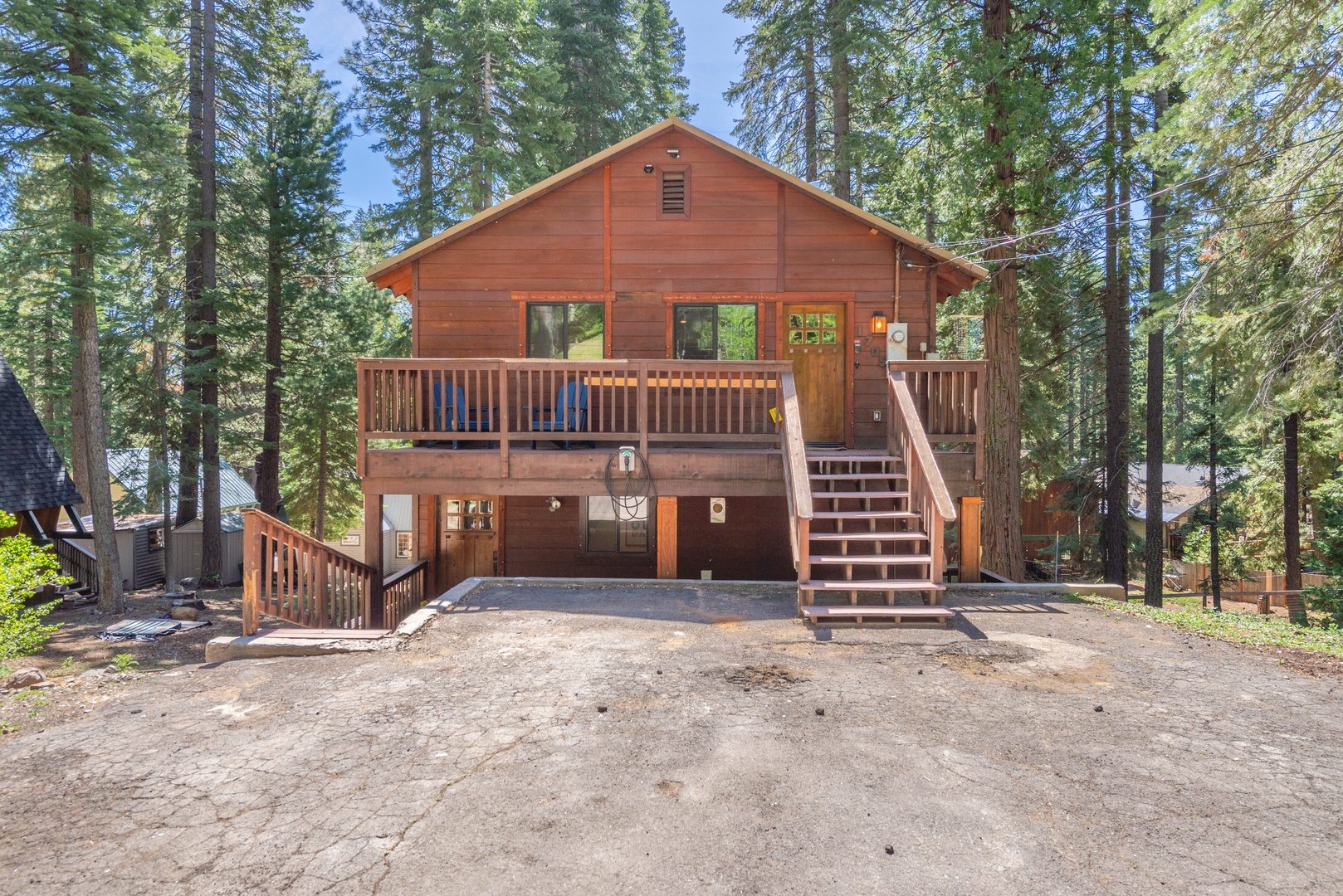Pull up to your charming wooden cabin nestled among towering pines, with spacious decks and convenient parking right at your doorstep.