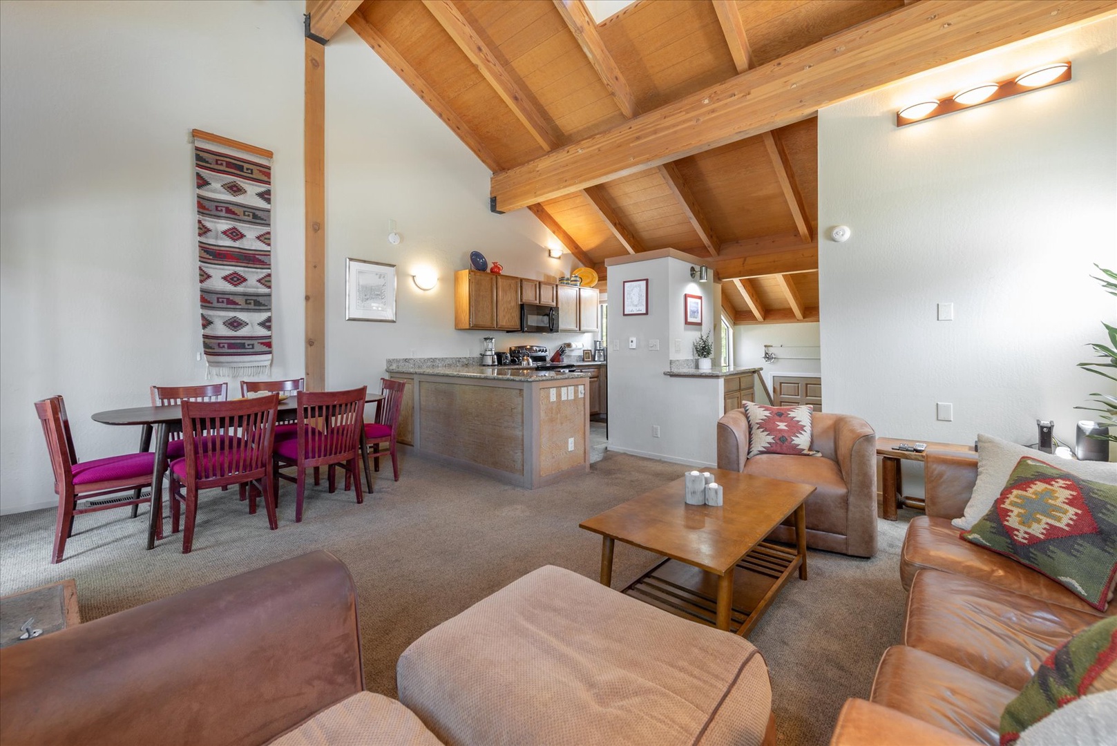 You'll love the soaring wooden beamed ceiling and open layout connecting your living, dining, and kitchen spaces—perfect for relaxing together after a day of adventure.