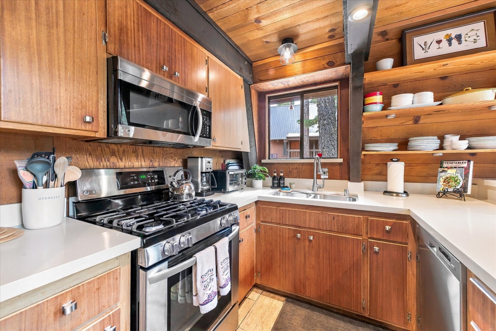 Step into your cozy cabin kitchen where warm wood surrounds you and everything you need is at hand—brew your morning coffee, cook up a feast on the gas range, and feel right at home.
