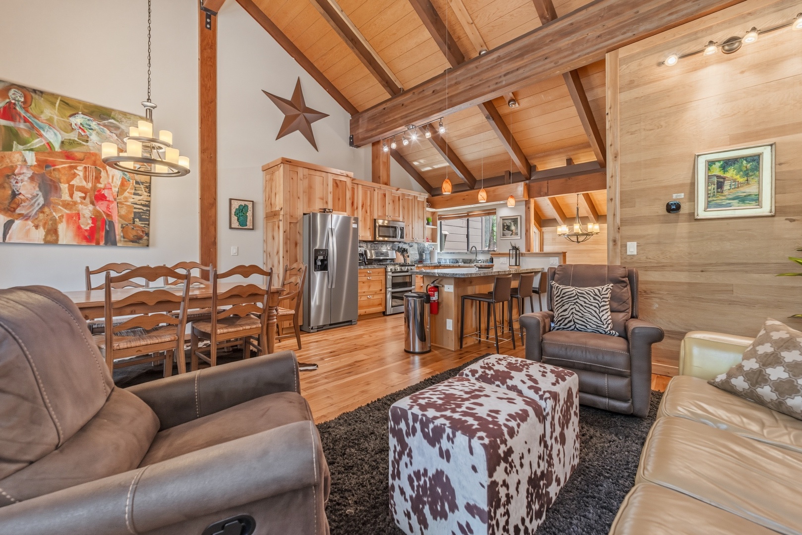 Step into your welcoming open-concept cabin retreat where warm wood tones, vaulted ceilings, and rustic charm invite you to unwind after mountain adventures.