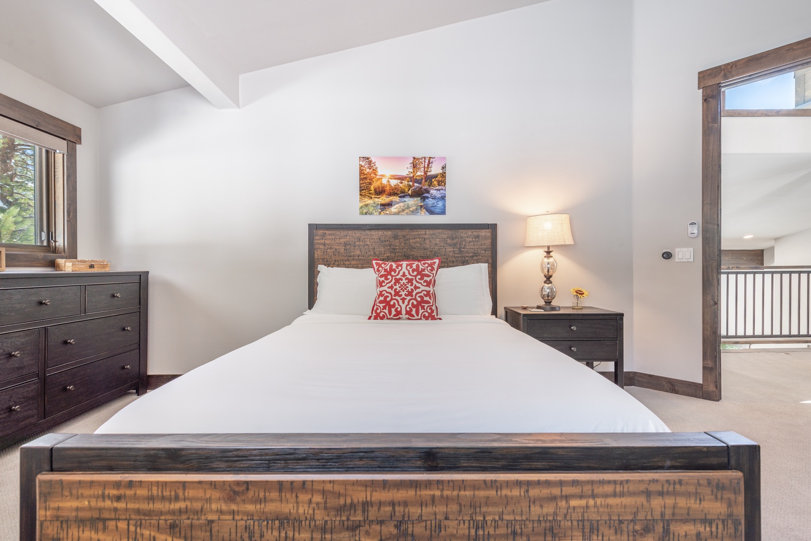 Sink into crisp linens and rustic charm in your peaceful bedroom retreat, complete with elegant furnishings and warm lighting.