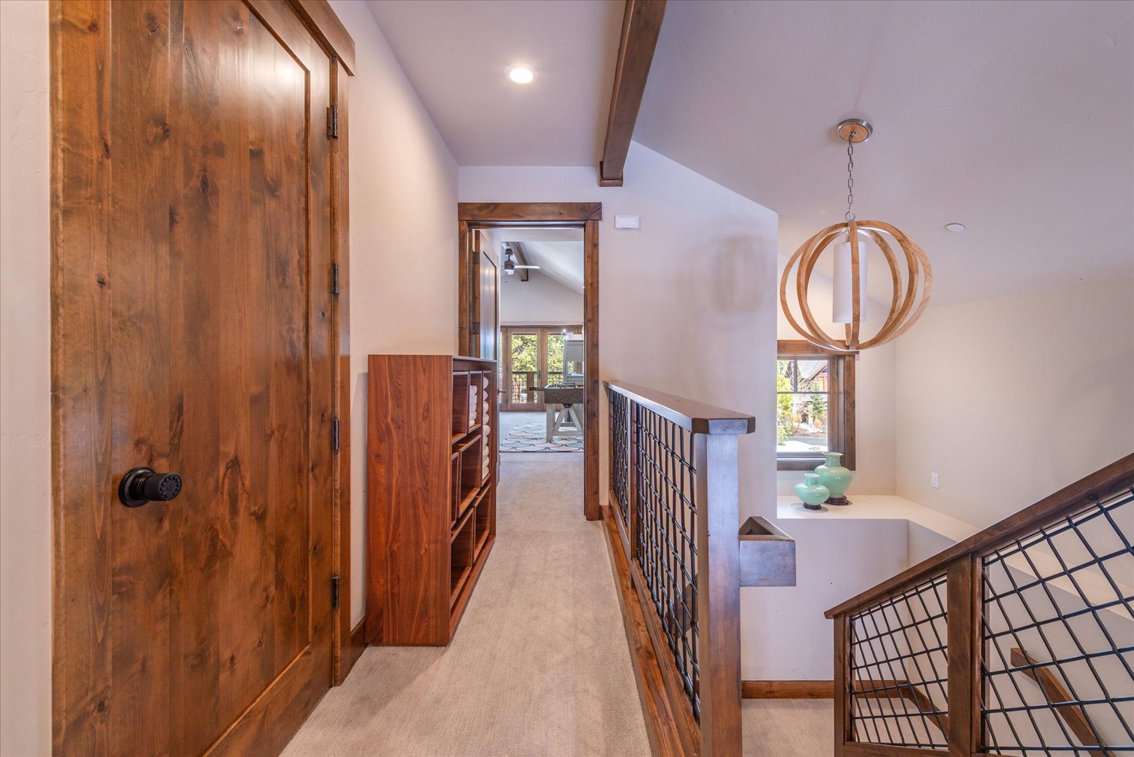 Step into this elegant hallway where warm wood tones and modern design create your perfect mountain retreat sanctuary.