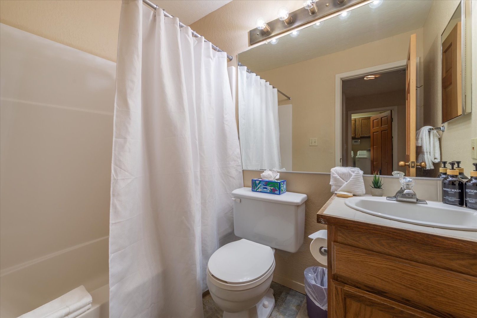 Your private bathroom offers everything you need to freshen up—a spacious shower, fluffy towels, and well-lit vanity stocked with thoughtful amenities for your comfort.