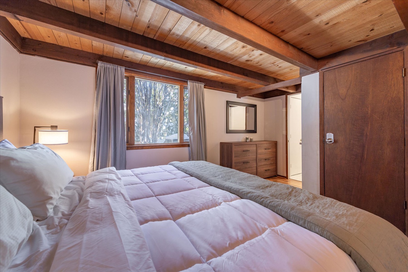 Settle in for a good nights rest in the master bedroom complete with a king size bed, plush bedding, and an ensuite bathroom.