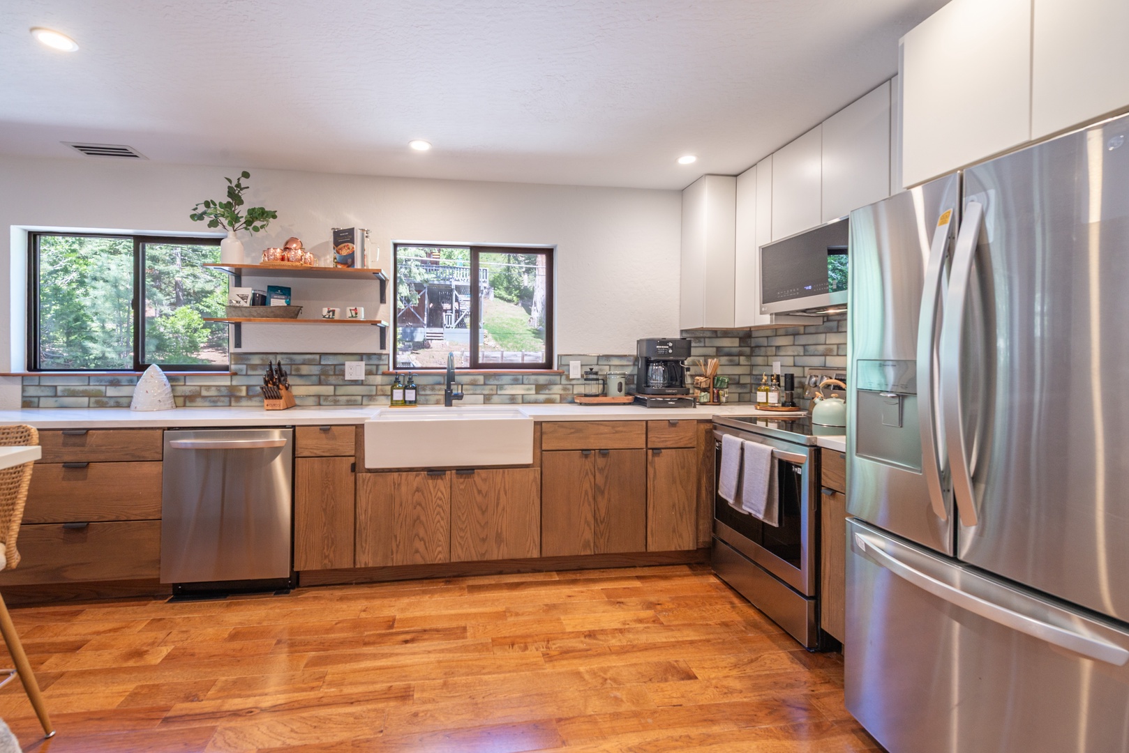 Your fully equipped kitchen blends warm wood cabinetry with modern appliances, perfect for preparing meals during your stay.