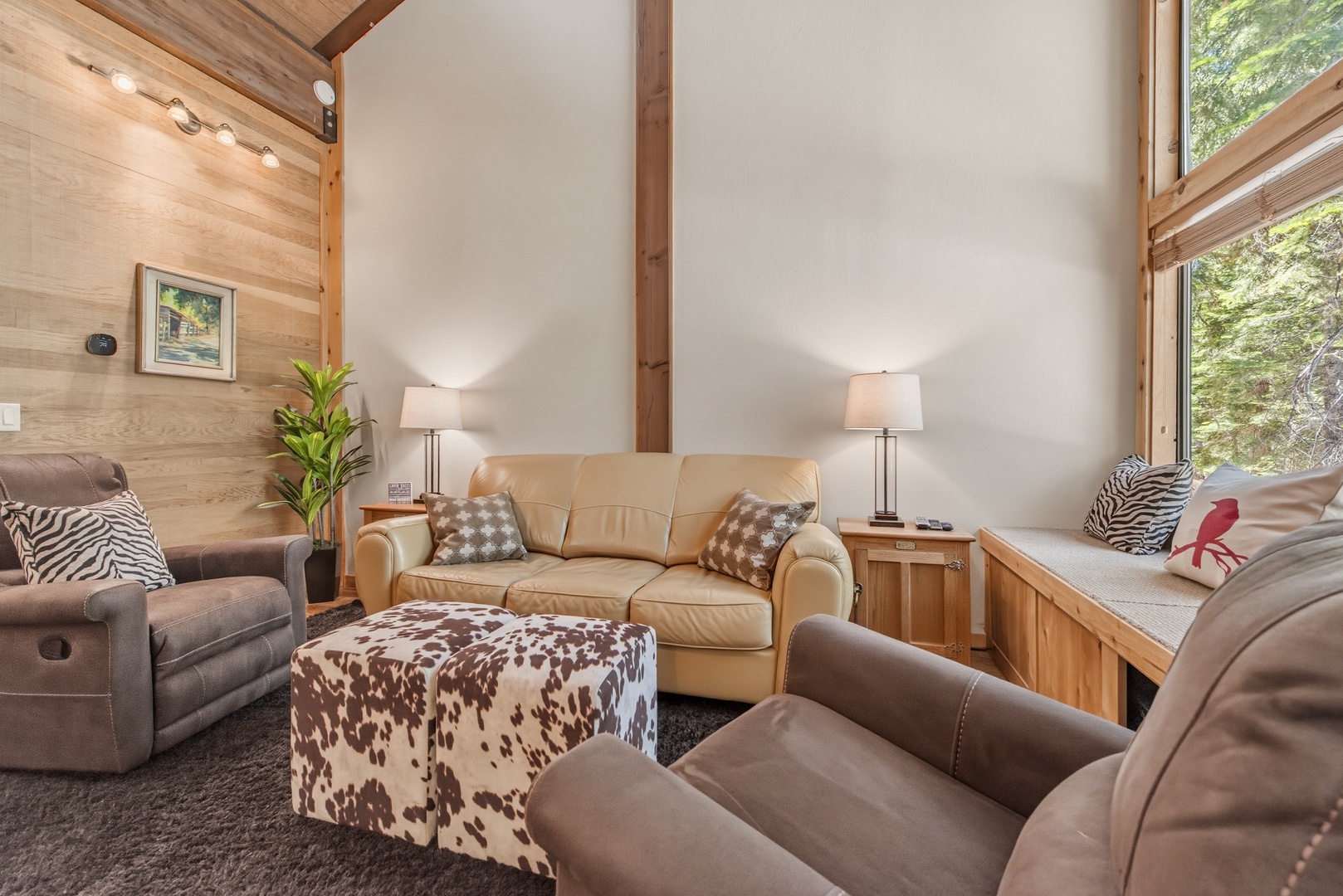 Sink into plush seating and let natural light pour through soaring windows, framing lush forest views. Your perfect retreat blends cozy comfort with stunning nature.