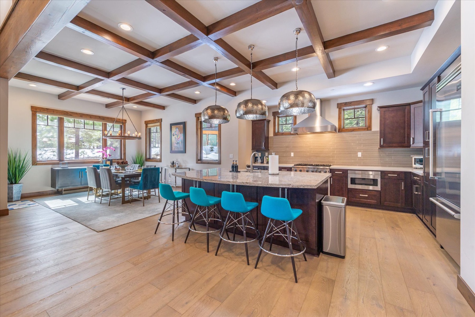 Gather around this stunning kitchen island with modern appliances and coffered ceilings, perfect for cooking memorable meals during your stay.