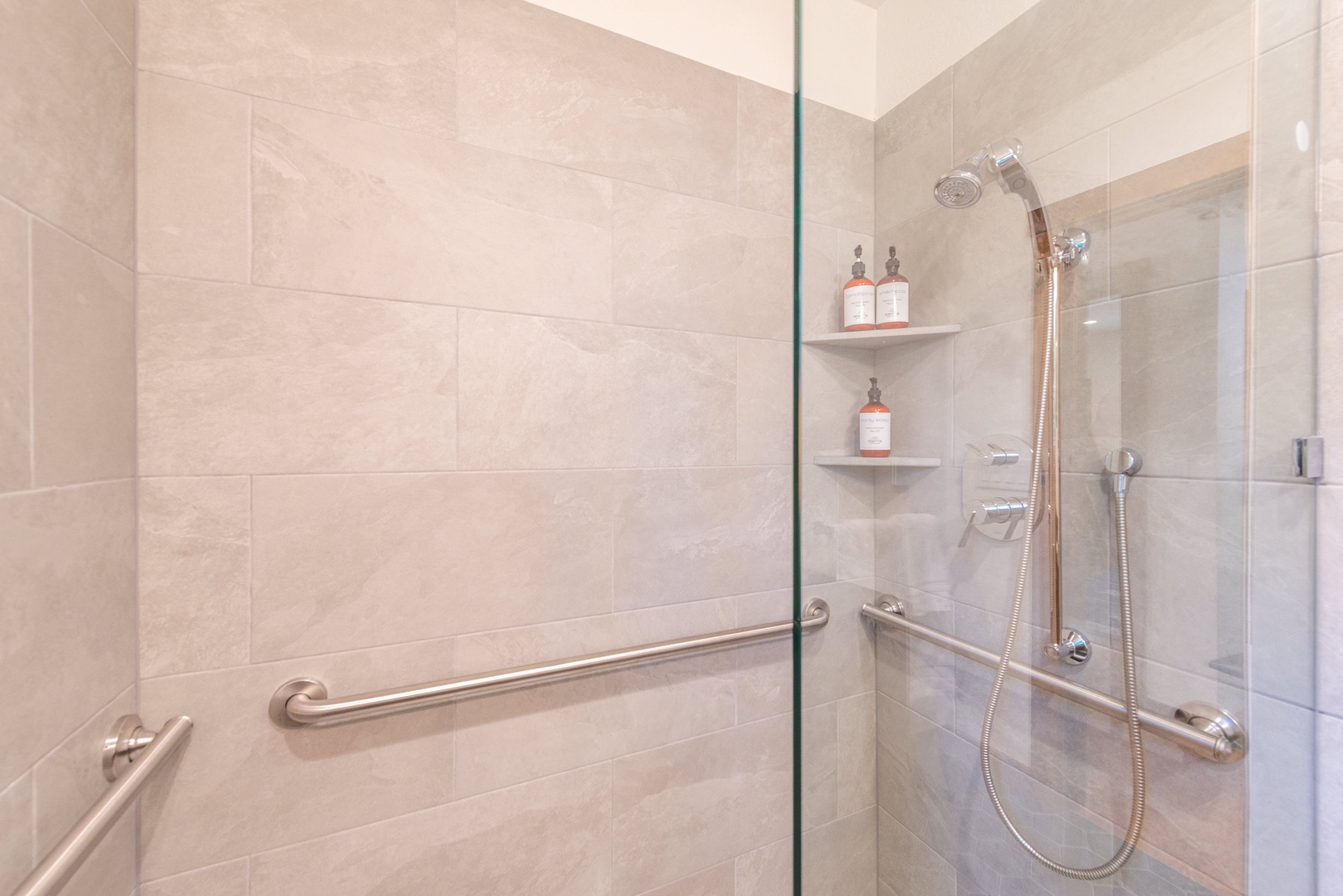 Step into your spacious shower with premium fixtures and provided amenities.