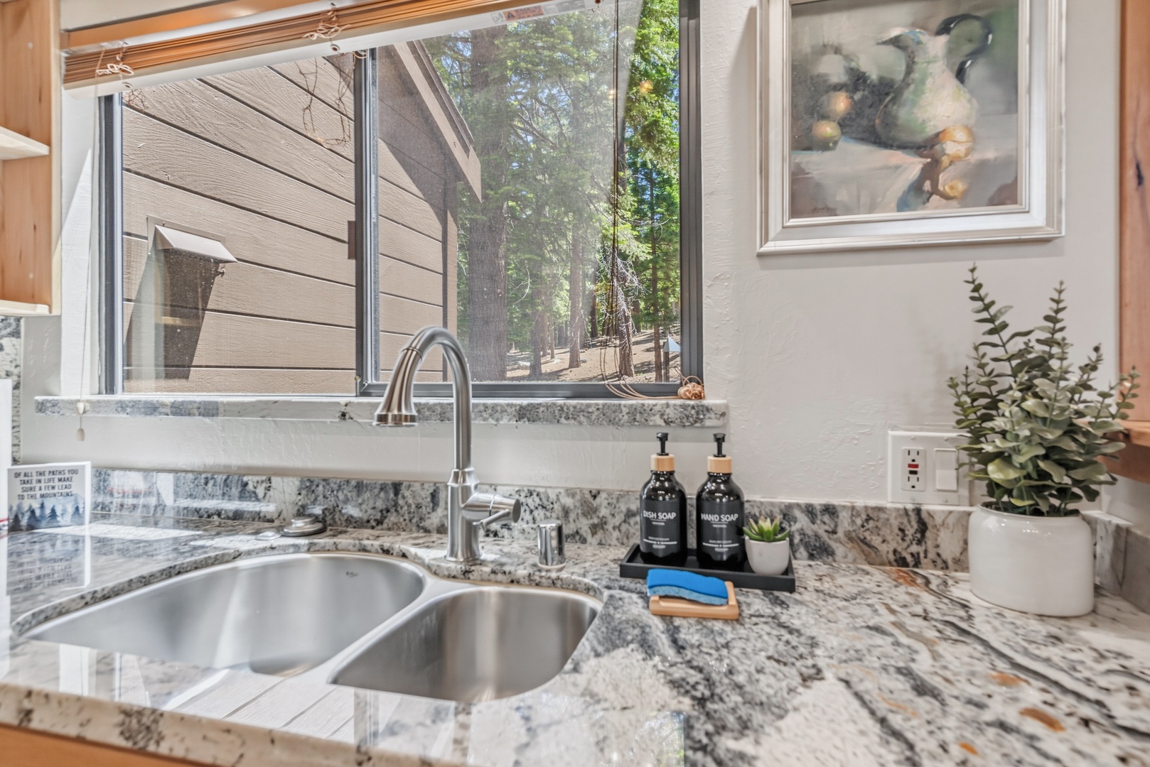 Rinse fresh produce or prep your favorite meals at this stylish kitchen sink, framed by a window overlooking the peaceful wooded surroundings.