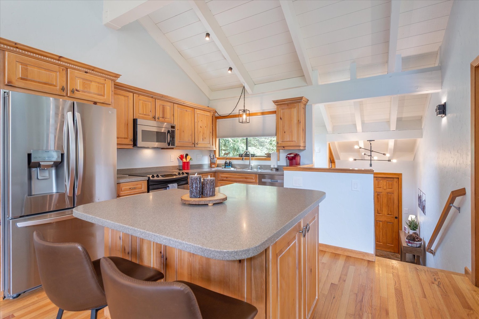 Picture yourself preparing meals in this bright, airy kitchen with gleaming appliances, warm wood cabinetry, and an inviting island perfect for morning coffee or evening wine.