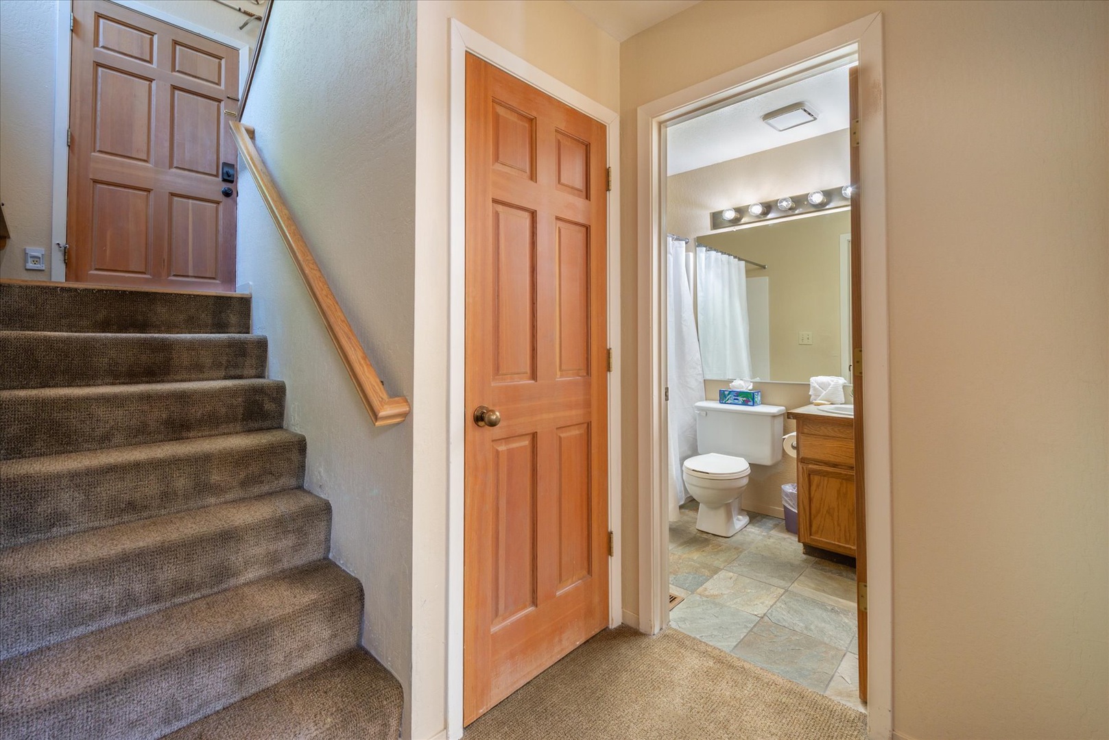 Step into your private bathroom featuring bright lighting, a spacious vanity, and a relaxing shower—ready for you to refresh after a day of adventure.