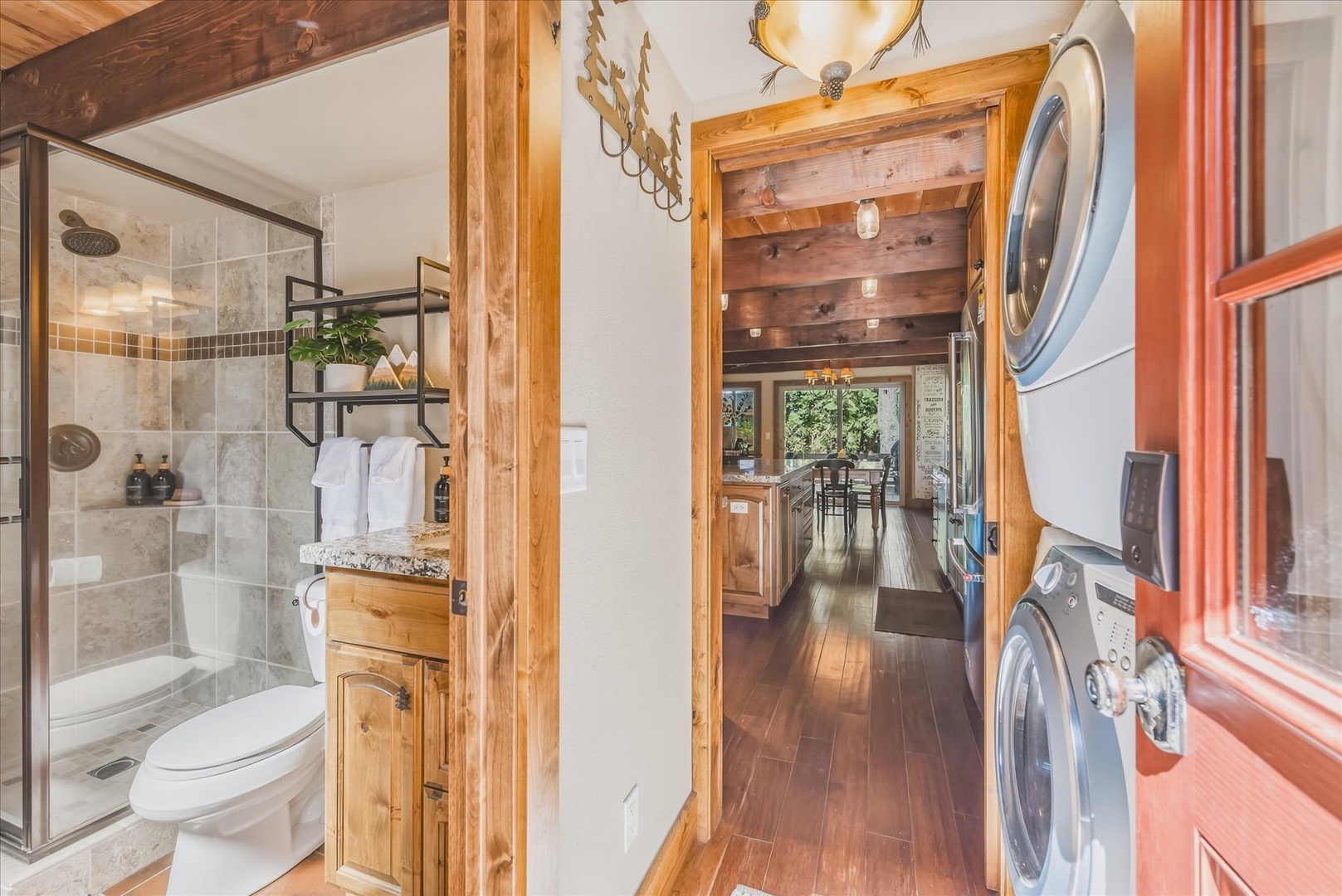 Your hallway entrance connects a full bathroom with a walk-in shower to an in-unit washer and dryer, making your mountain retreat both luxurious and convenient.