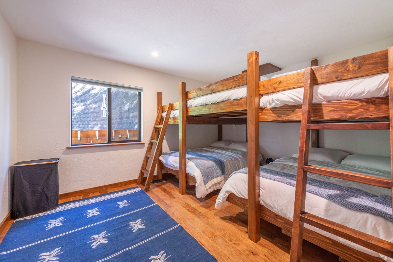 Sleep soundly in this inviting bunk room where handcrafted wooden beds and cozy linens create the perfect space for your group to rest and recharge after a day of adventure.