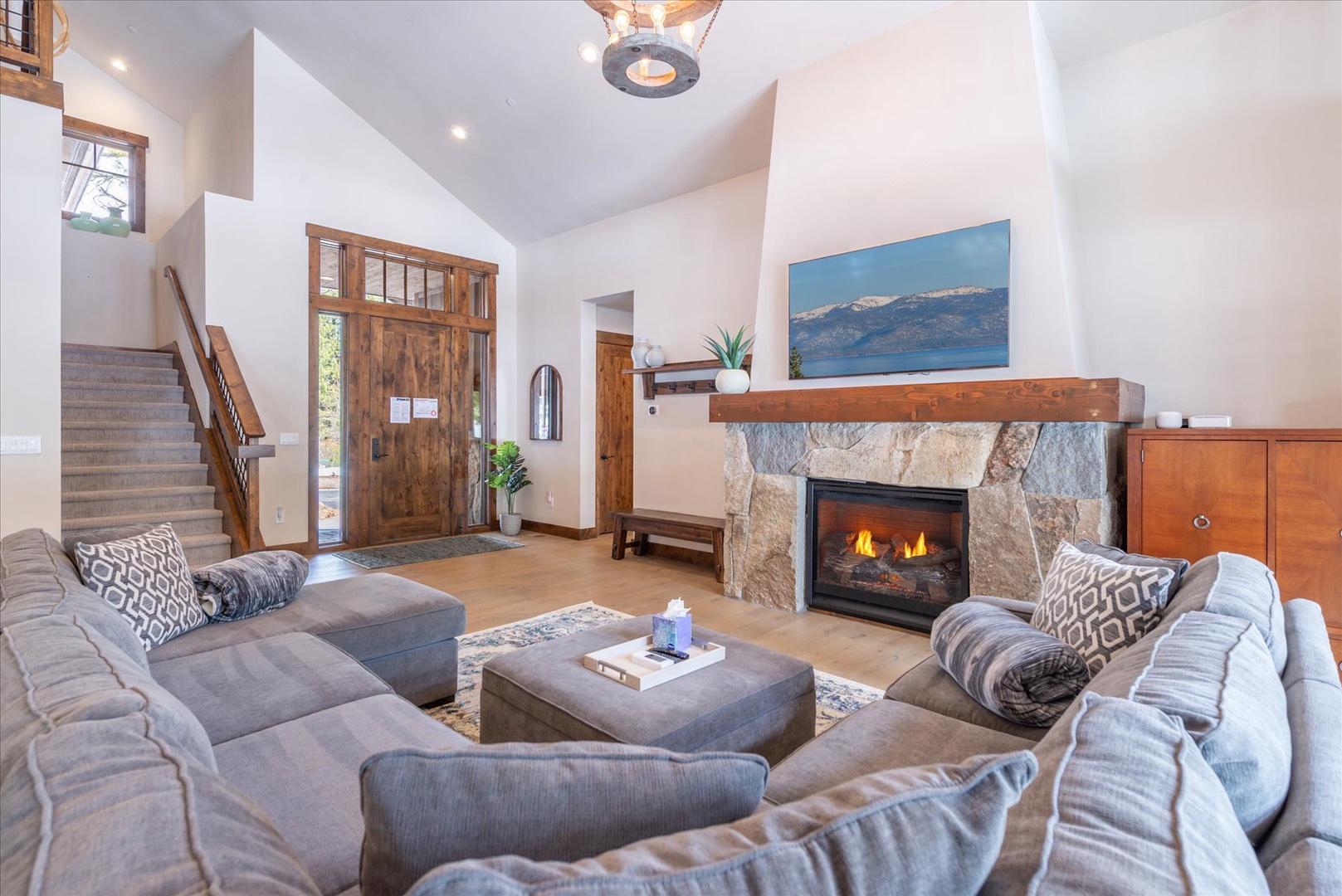 Sink into plush seating by your crackling fireplace, where warm wood tones and mountain views create your perfect retreat.