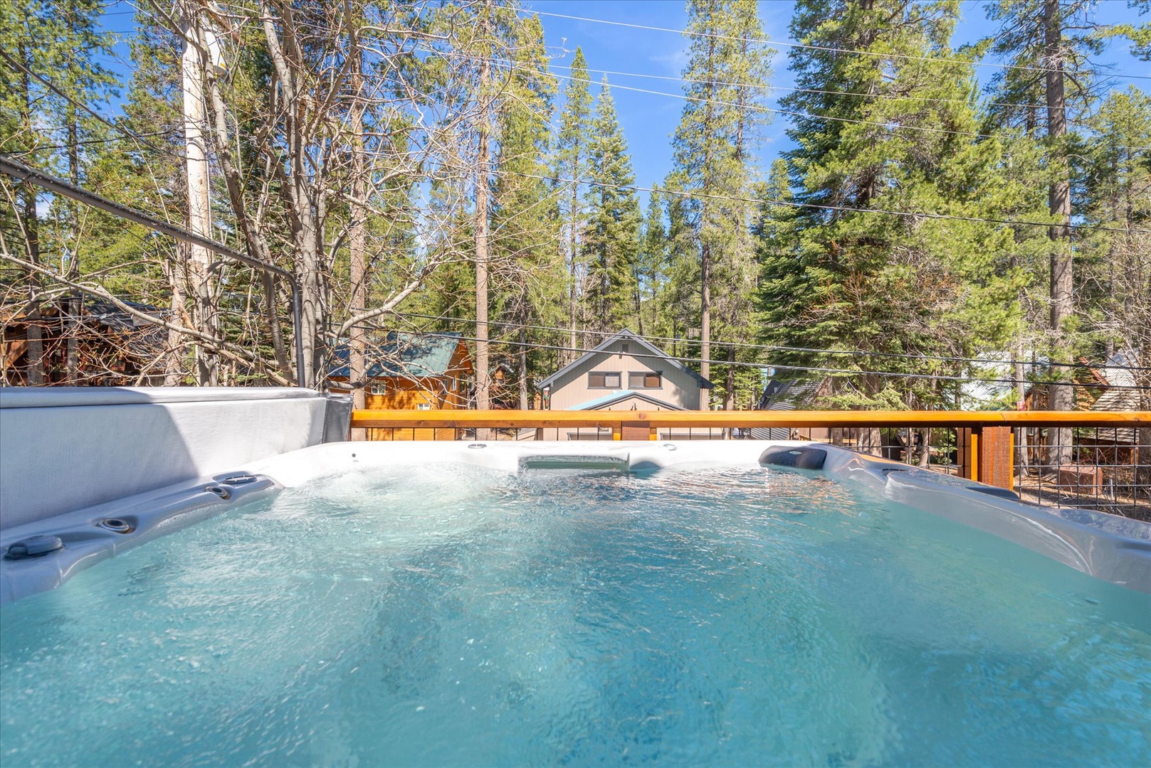 Soak your worries away in this private hot tub surrounded by towering pines and mountain views.