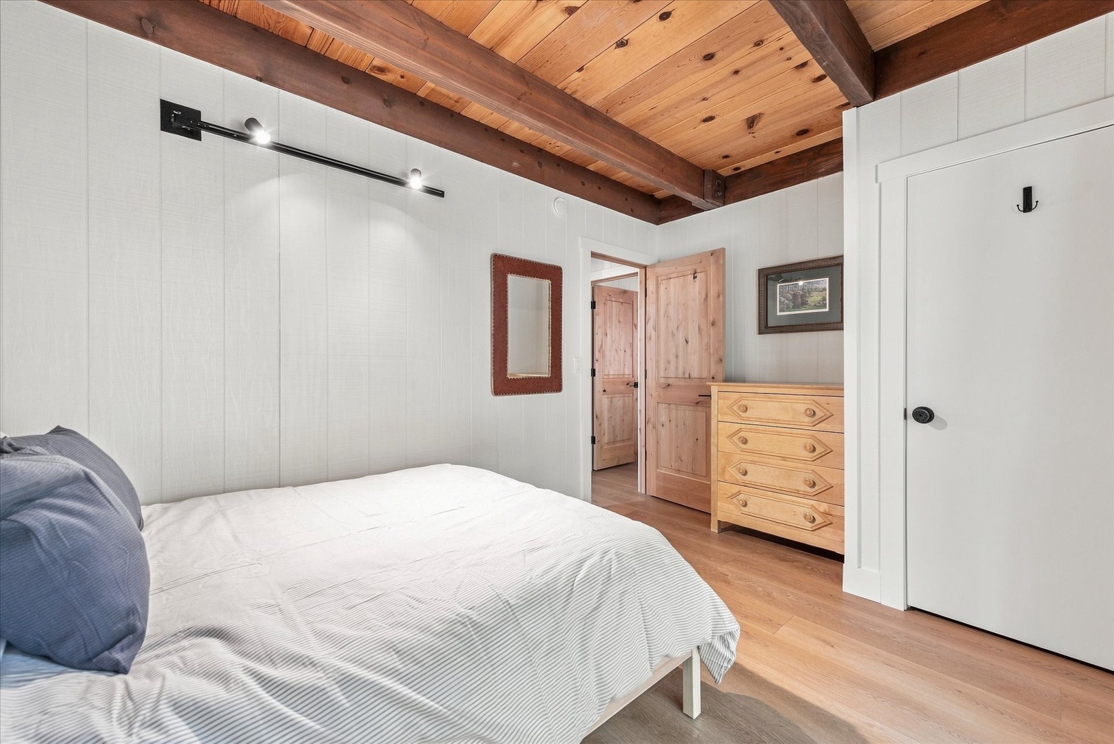 Relax in this bright, serene bedroom. Your peaceful retreat features soft linens, warm wood accents, and plenty of natural light—perfect for unwinding after a day of adventure.