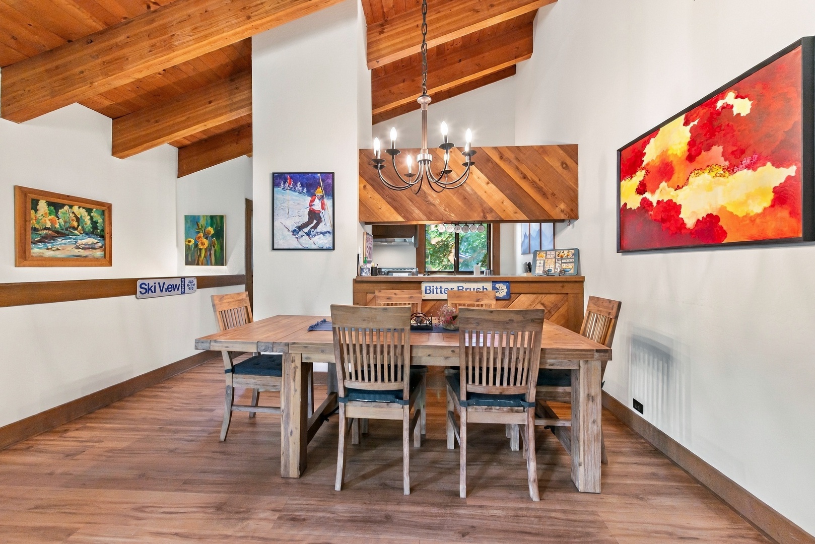 Gather around the rustic wood dining table under vaulted ceilings with warm exposed beams—perfect for morning coffee or evening game nights with your group.