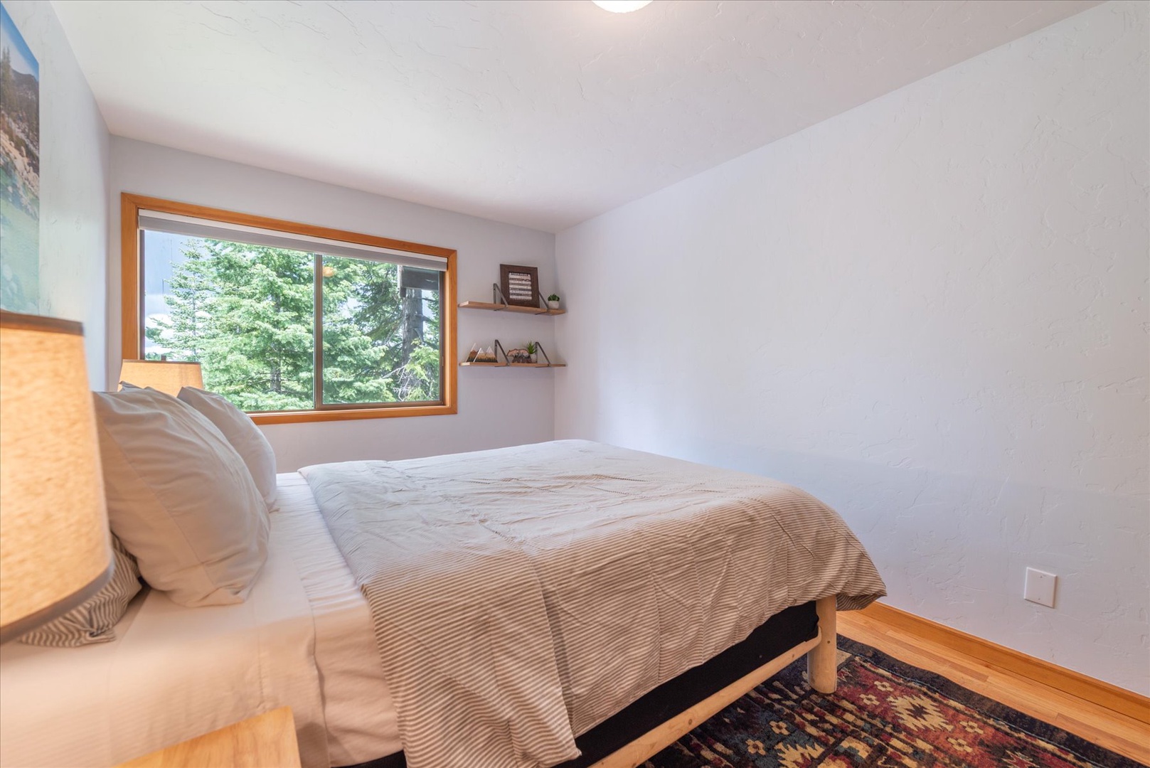 Wake up to fresh mountain air and forest views framed by the natural wood window. This king cozy bedroom offers a peaceful retreat with warm, minimalist touches for restful nights.