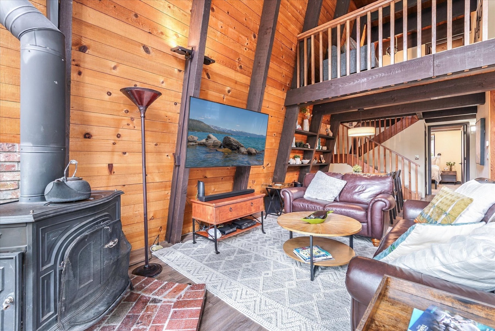 Sink into buttery leather sofas warmed by the crackling wood stove, gazing up at soaring pine ceilings and the cozy loft above.