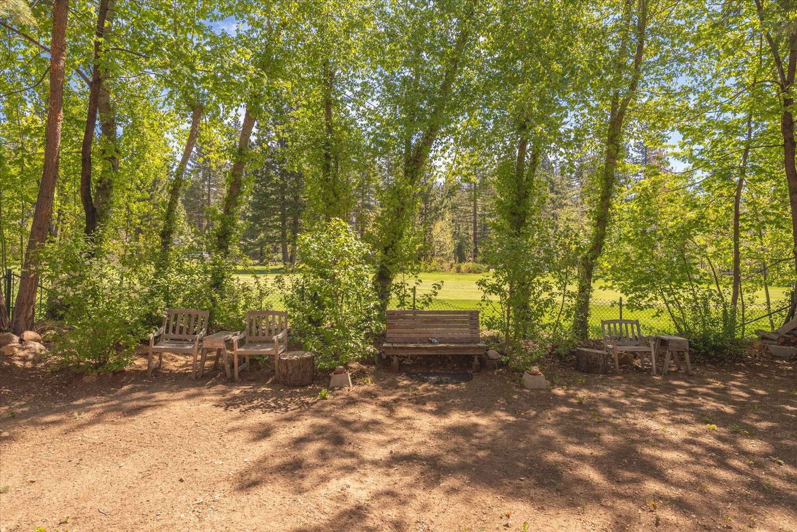 Find your peaceful retreat in this shaded seating area, with wooden benches perfect for morning coffee.
