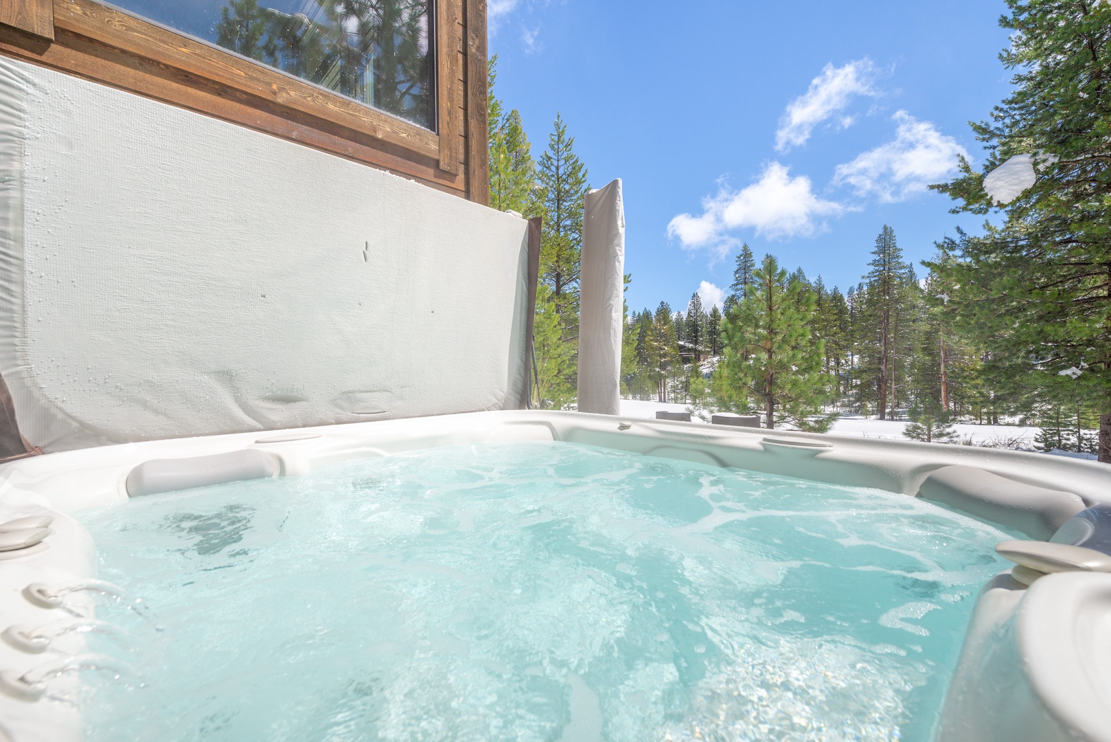 Soak in your private hot tub while gazing at snow-dusted pines and crisp mountain air.