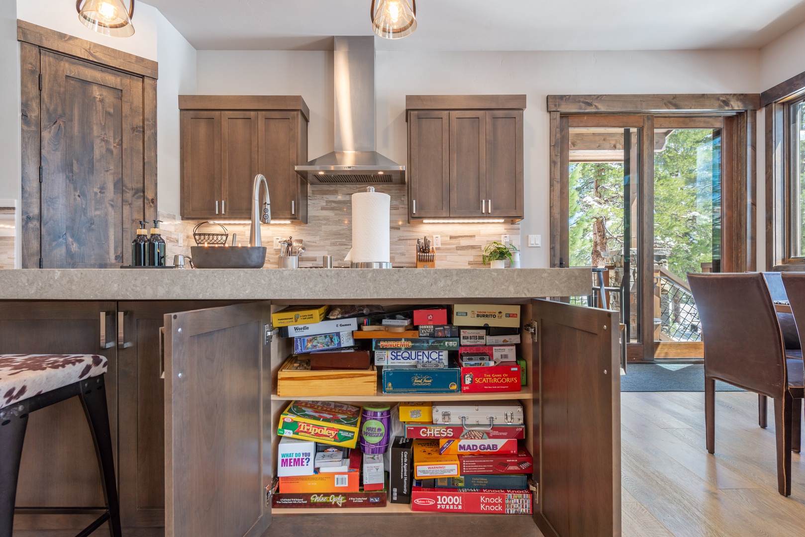Your gourmet kitchen features modern appliances and a surprise games cabinet - perfect for cooking together and entertaining on cozy evenings.